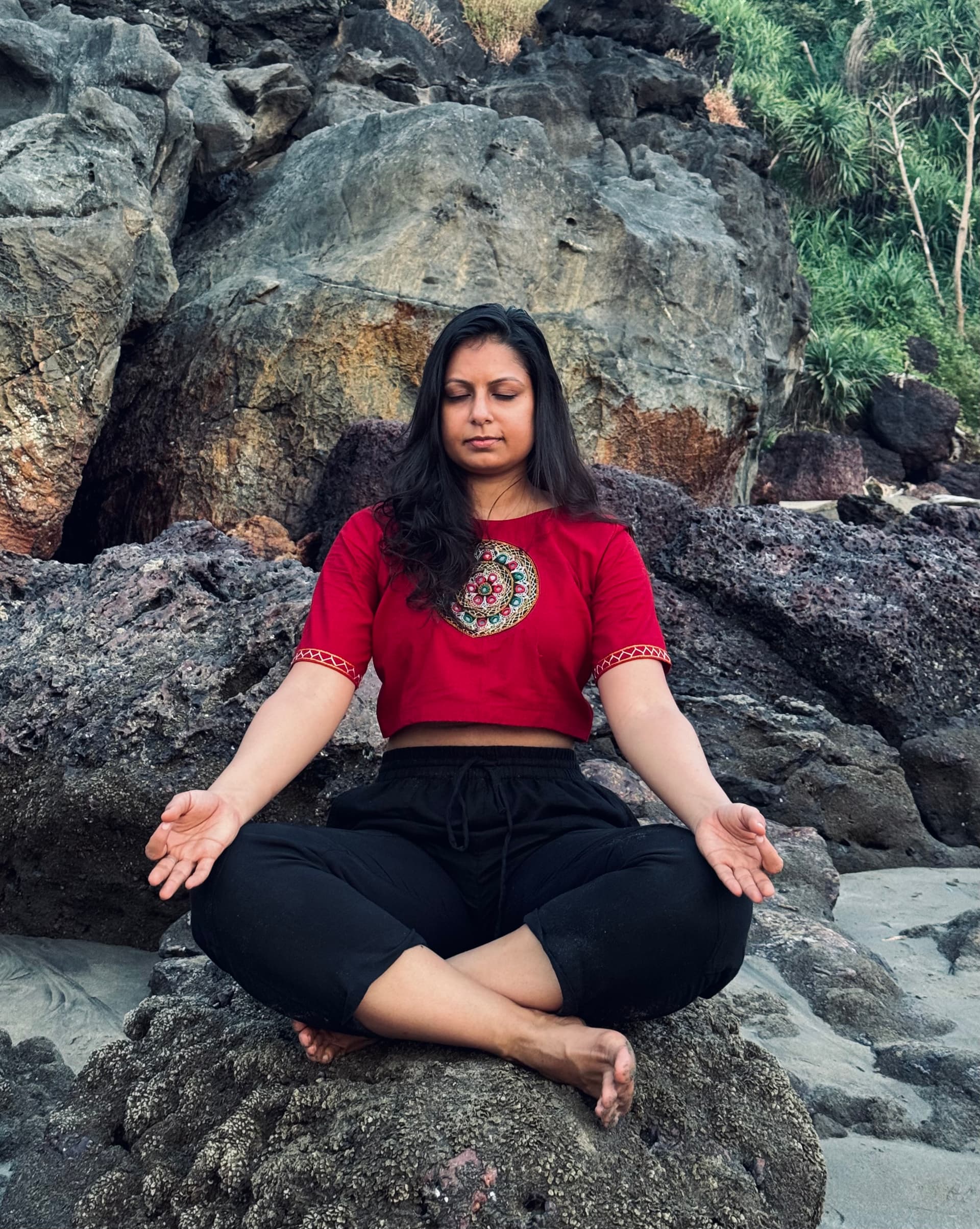 Nikita Sharda practising yoga on a beach